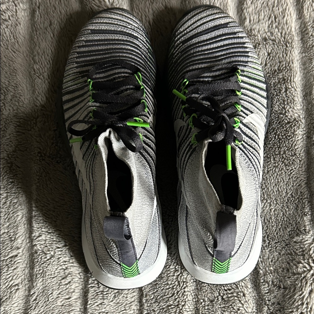 NIKE Striped Black and White Athletic Shoes with Green Accents